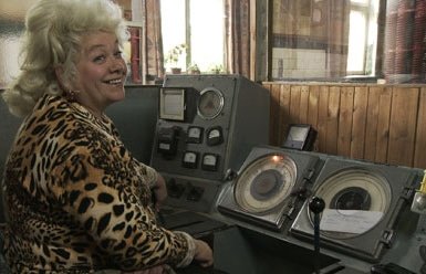 Woman smiling in front of old machines
