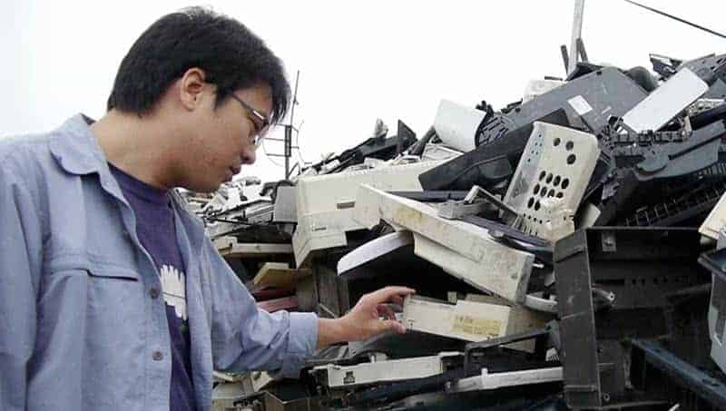 Chinese man inspecting e-waste