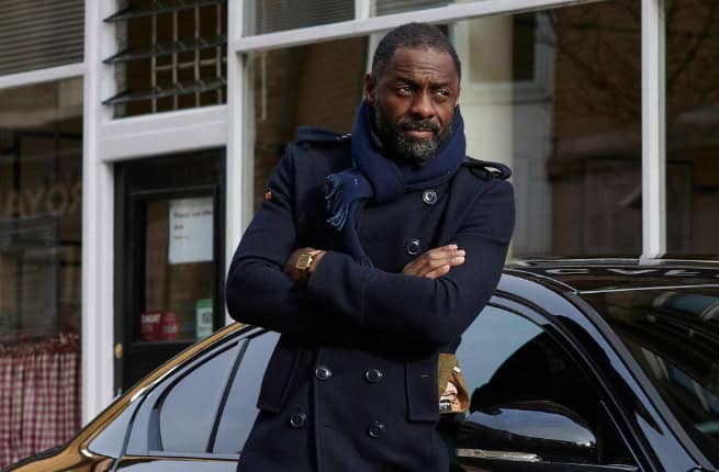 Idris Elba in front of sports car