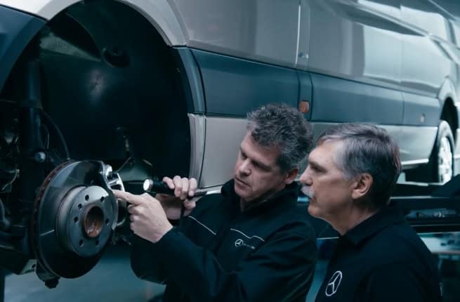 Two car mechanics with sprinter