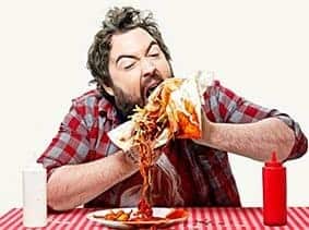 Man stuffing food in his mouth