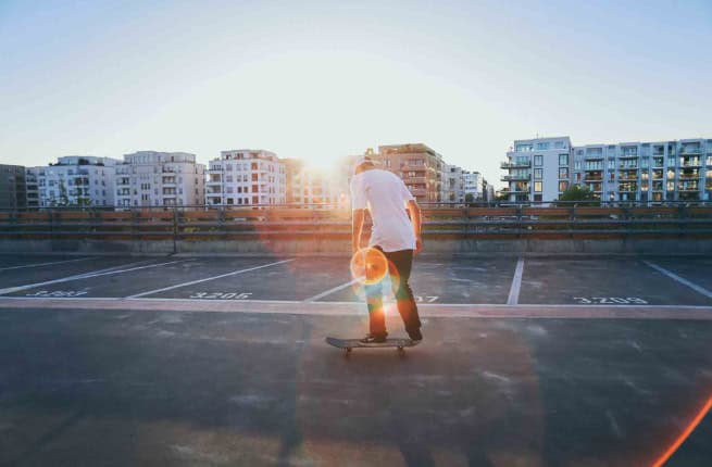Skater on parking deck at sunset