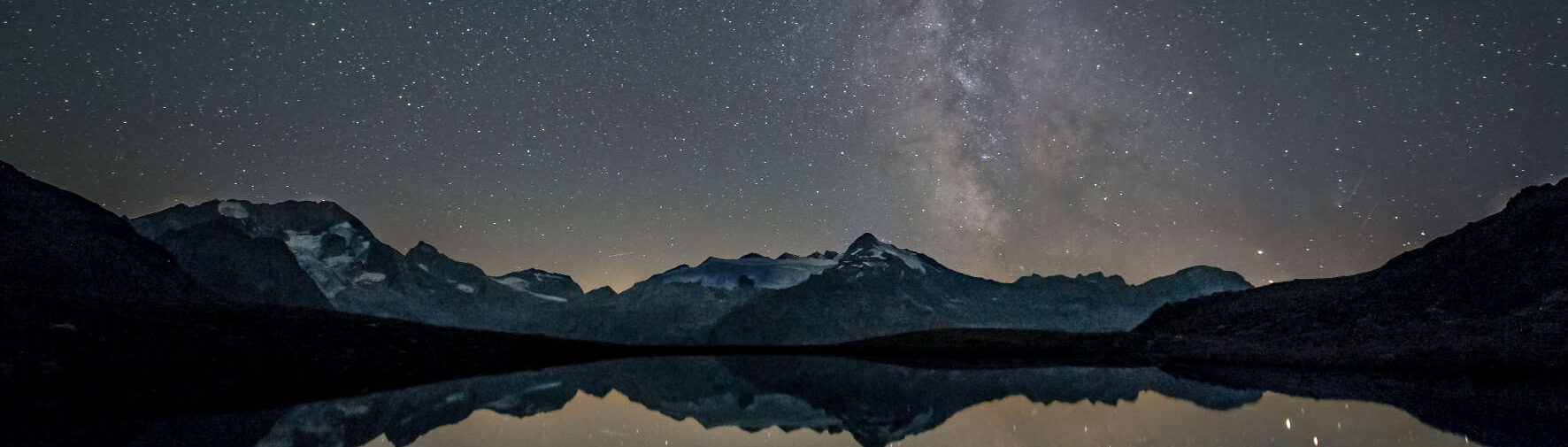 Alpine lake location at night