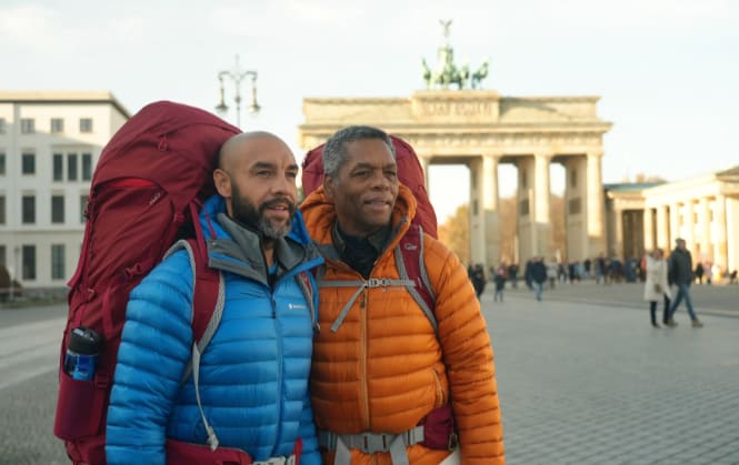 Contestants with backbacks in front of Brandenburger Gate in Berlin