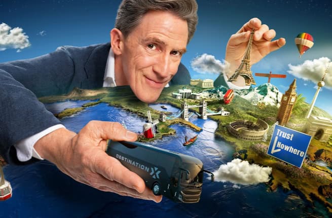 presenter of Destination X with miniature Europe model