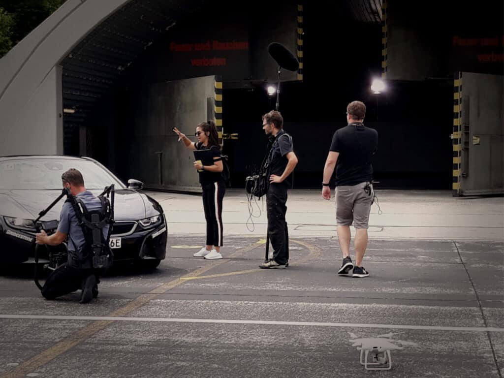 Production crew shooting a car